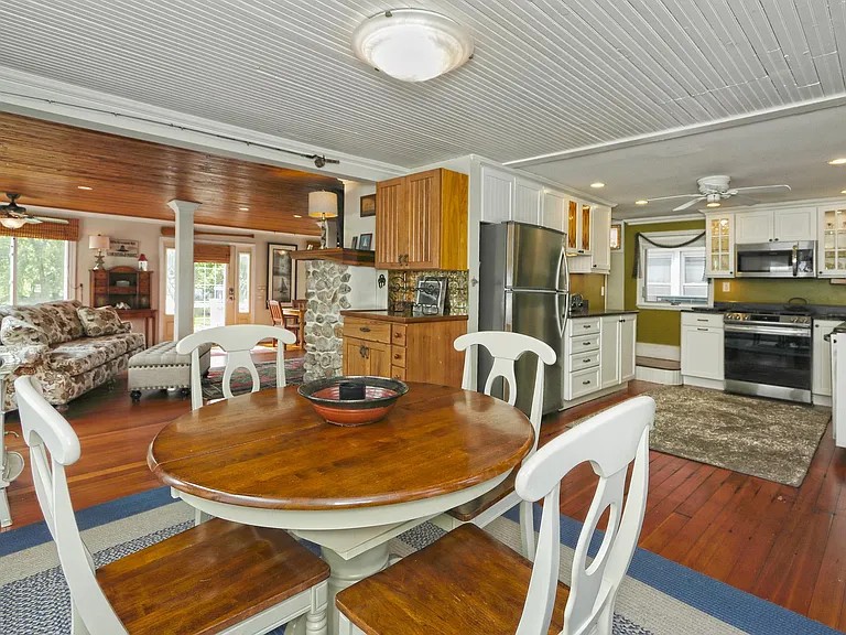 Open view from dining area into kitchen and living room.