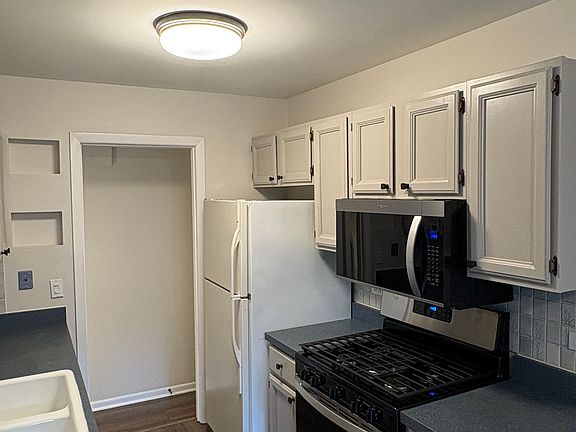 Kitchen with new stove and microwave