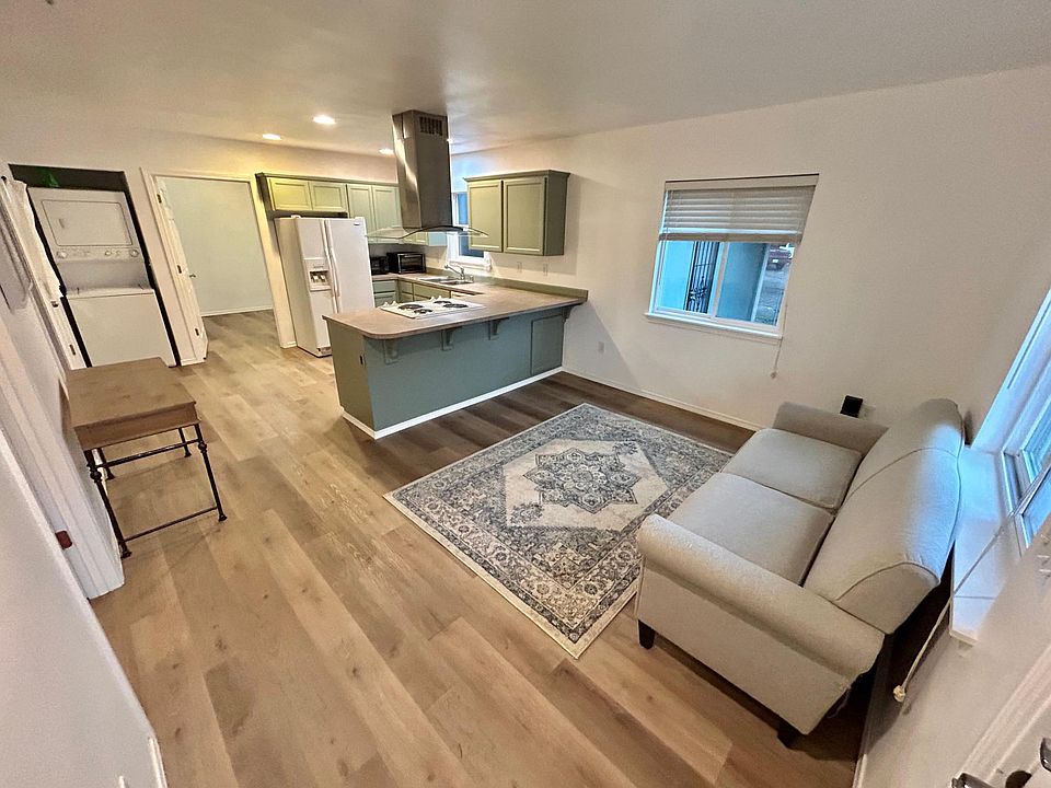 Living room, kitchen, and laundry view.