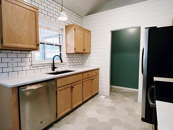 Newly renovated Kitchen with tile floors, subway tile backsplash, quartz countertops, stainless steel appliances, and deep basin sink!