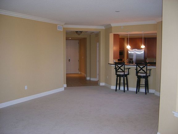 Entrance into condo with kitchen to right & dining area.  View from Family Rm.
