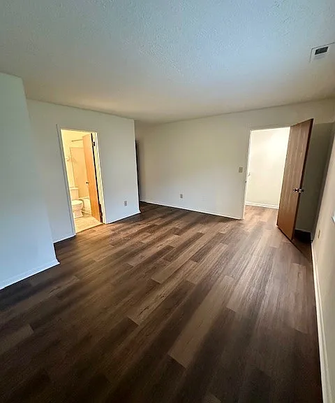 Primary bedroom- walk in closet on the right, bathroom is the door on the left
