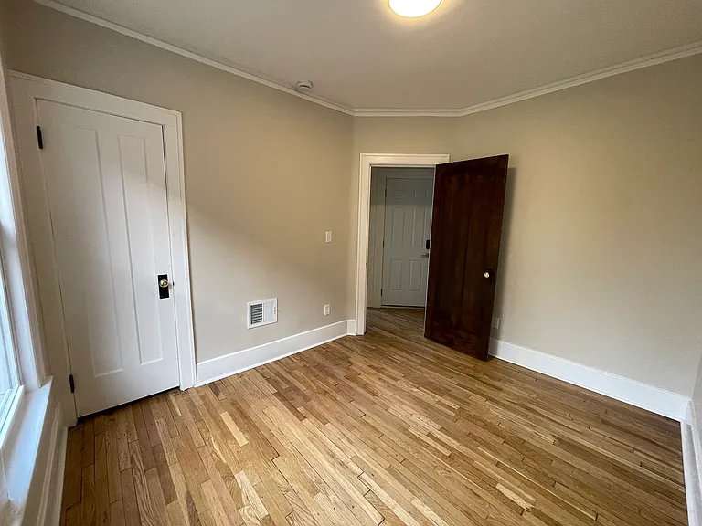 first bedroom with view of back door