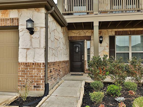 Beautiful stone and brick elevation, pretty landscaping, front porch