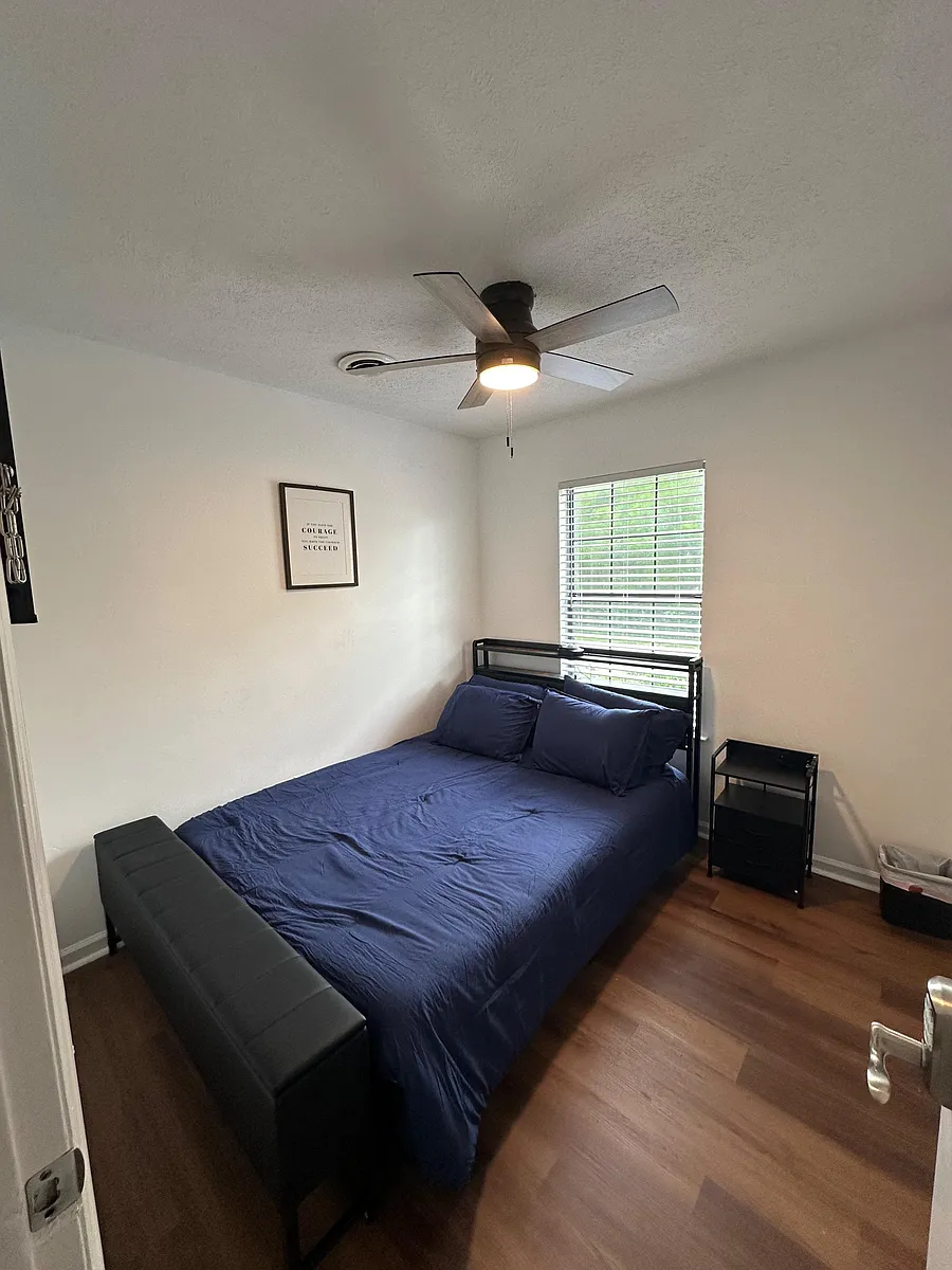 Furnished room with queen bed & nightstand charging station, ceiling fan with light, blinds for privacy and natural light. - Avondale Cir