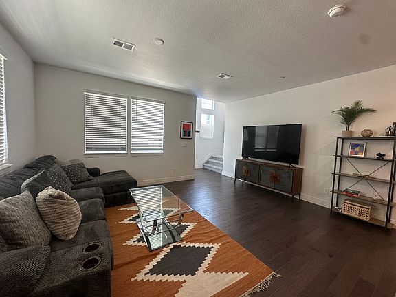 Large living room with couch and TV