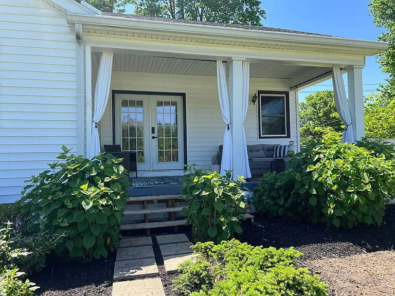Front porch overlooks garden.