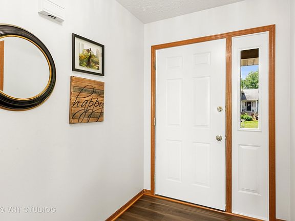 This welcoming foyer has a coat closet and entrances to both the formal living room and the family r