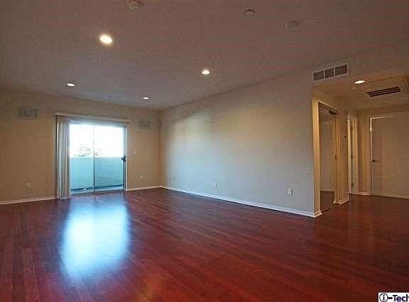 Spacious living room with adjacent balcony.