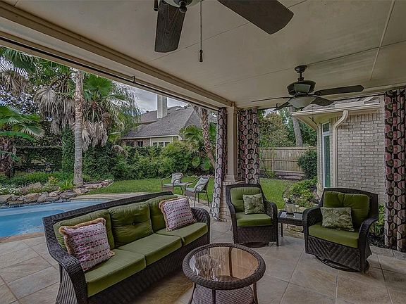 The covered back porch is wonderfully designed for family enjoyment as well as entertaining friends. The views from the porch are extraordinary. Most importantly, notice the exceptionally high degree of privacy created by the lush and dense landscapi
