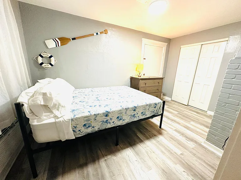 Queen size bed with a new 12 inch hybrid mattress dresser closet and tv