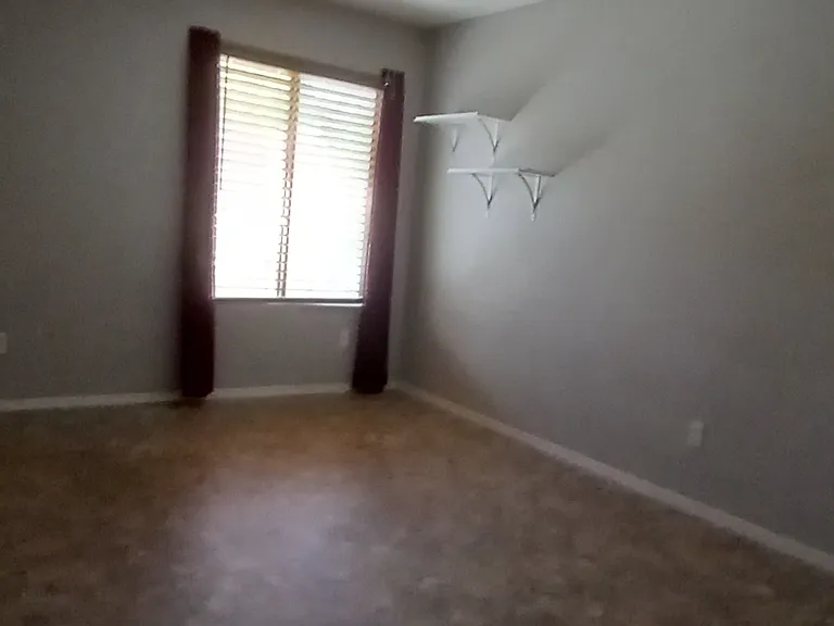 Larger room with tiled floors, ceiling fan with remote.