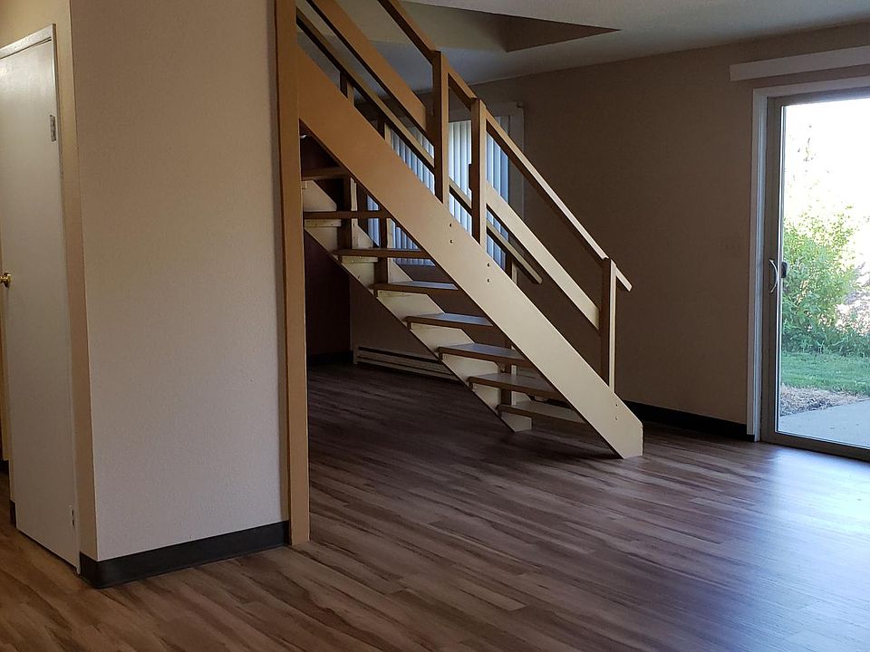 The staircase to the upstairs separates the living and dining rooms.