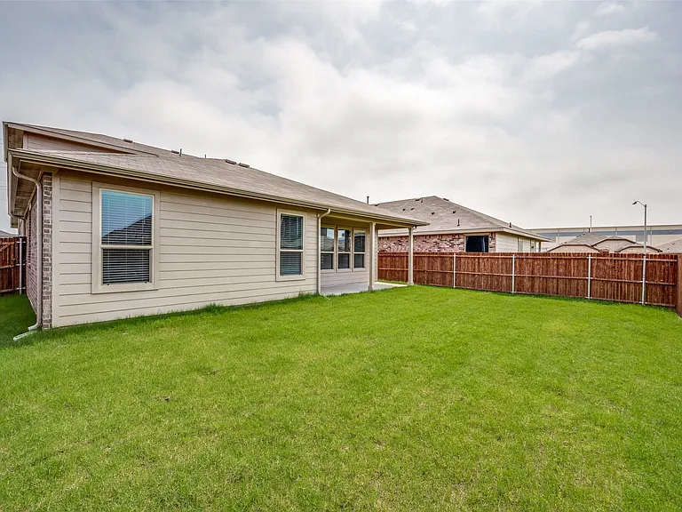 Rear view of house with a yard