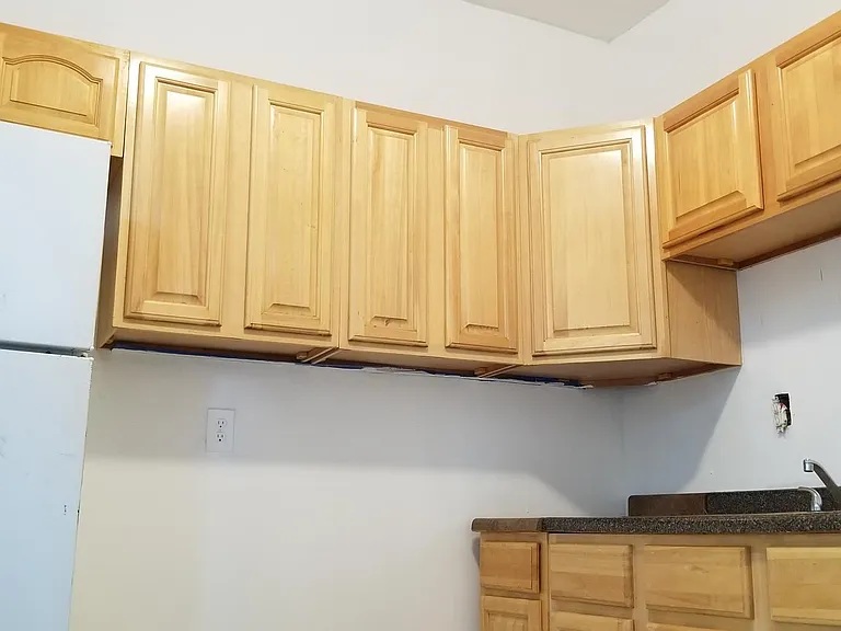 Retro picture of kitchen. Kitchen being newly renovated, new countertops and newly tile floor.