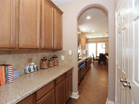 Across from this long butlers pantry, double doors open to your pantry.
