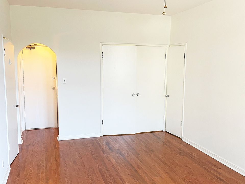 Main room facing entry hall and front door; 3 wall closets