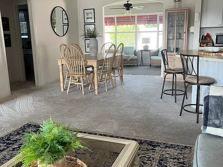 View from living room into dining area and sunroom.
