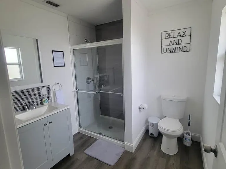 Fresh and spotless bathroom with sink, toilet, shower, and essentials