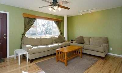 Bright airy living room with ceiling fan