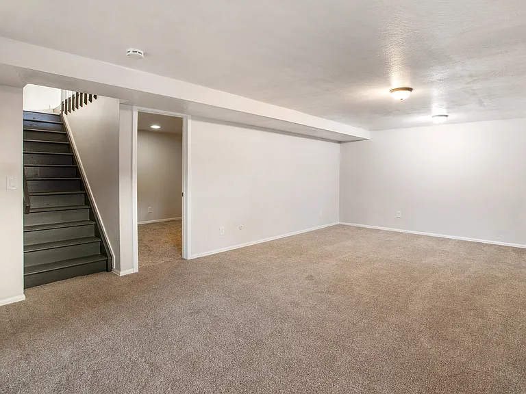 Basement lookig up stairs and bedroom
