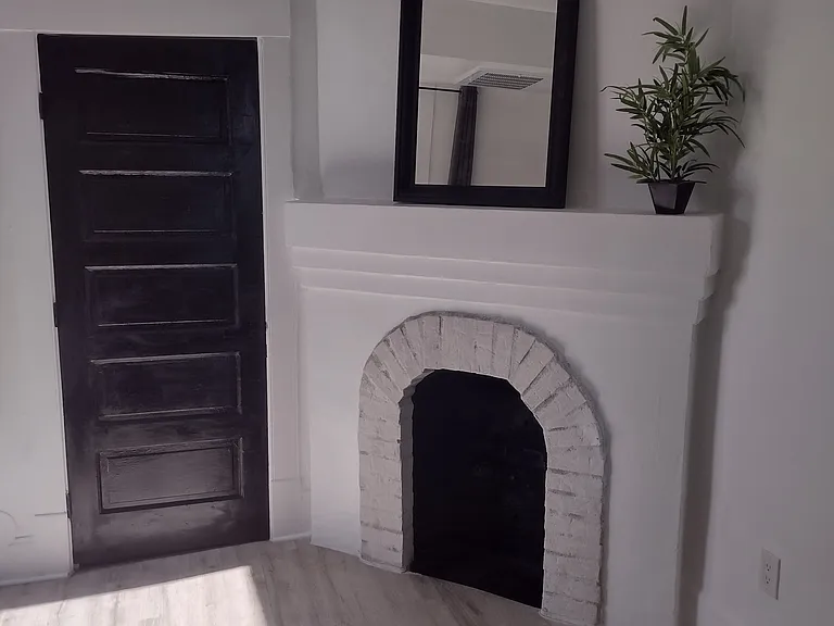 Faux fireplace and door to closet