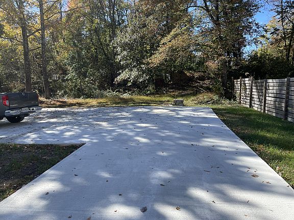 Huge driveway and parking pad, sits on almost a half-acre lot!