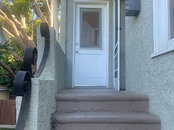 Kitchen door on the left and front door with screen door on the right
