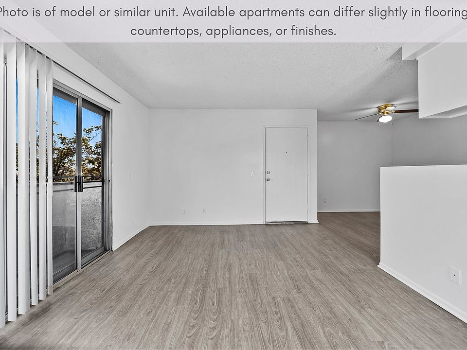 Spacious living space featuring natural light and sliding door access to the balcony.