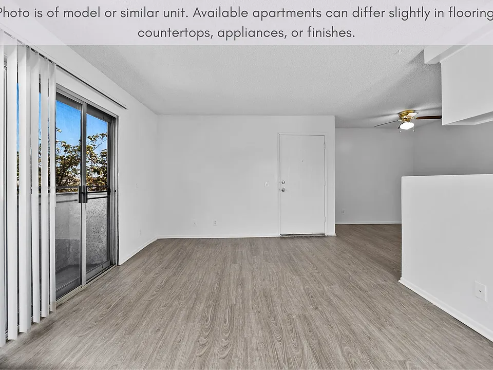 Spacious living space featuring natural light and sliding door access to the balcony.