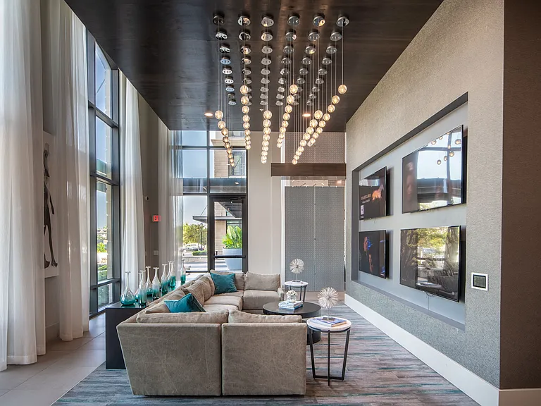 Community Lounge with TV Wall and Plush Sectional Seating
