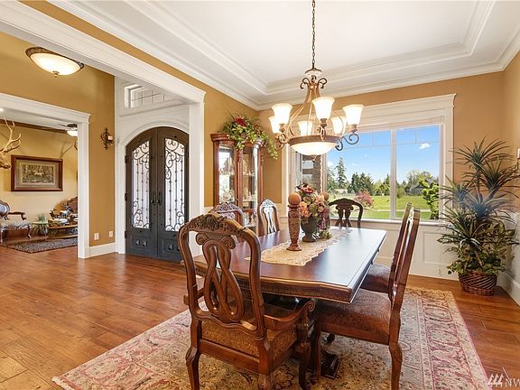 The graceful dining room caters to large gatherings or an intimate candlelit dinner.  Beautiful ceiling detail and wainscoting.