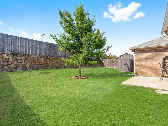 View of yard with a storage shed and a patio area