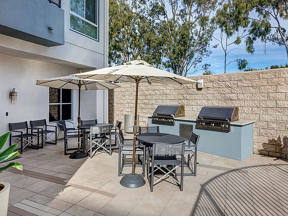 BBQ area with tables, chairs, and two BBQ's.