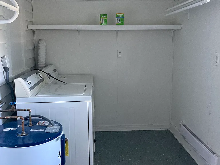 Laundry room is spacious with extra room for storage.
