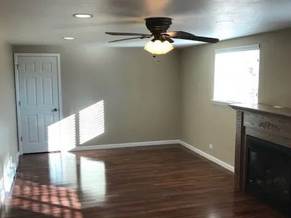 Living room with gas fireplace and door to small office