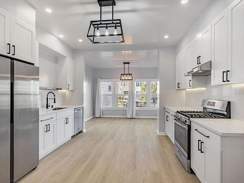 Main level: eat in kitchen with an adjacent sunroom that can be used as a work or recreation area. View from front entrance.