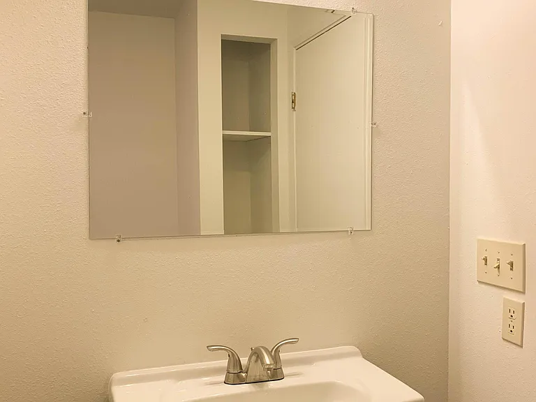 Sink/mirror located in downstairs bathroom.