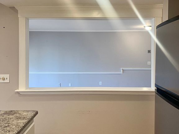 POV: Standing in kitchen with living room on the other side of the opening