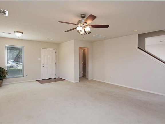 Another view of living area looking at front entrance and hall to 1/2 bath.