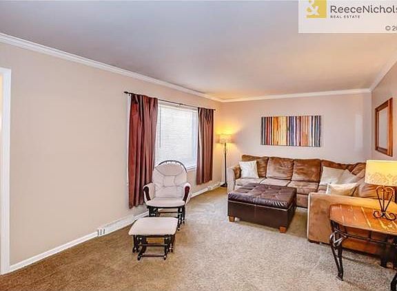 Living room area is carpeted for comfortable living.