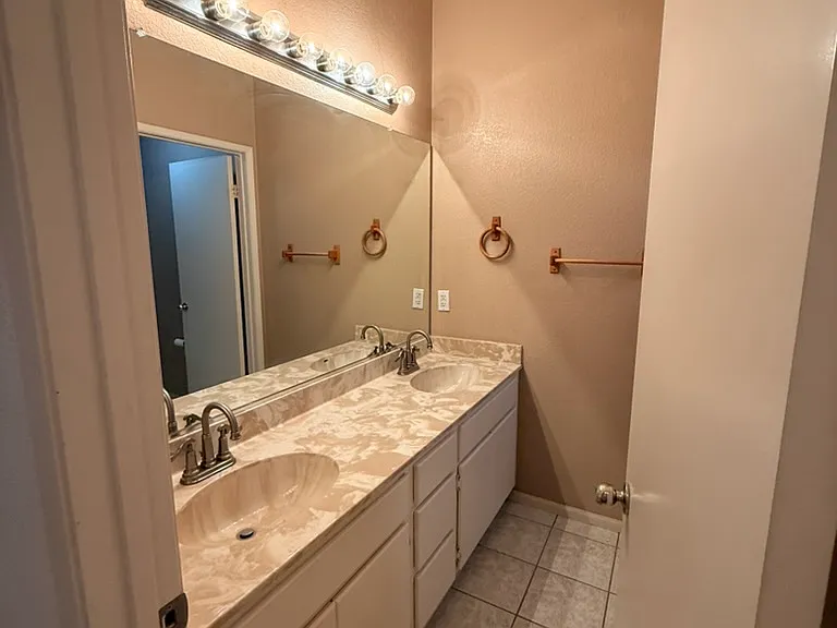 Bathroom, first floor, off hallway of bedrooms 1, 2, and 3.
Two sinks, shower tub combo