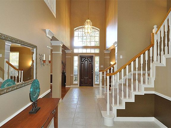 As one enters the home, there is a dining room on the right, aliving room on the left, and a large open family room as one heads down the hallway.