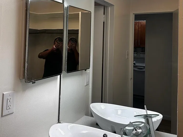 Bath vanity with mirrored medicine cabinet. Flattering indirect lighting.