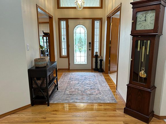 The dining/sitting room is to the left, and the bedroom is to the right of the front door.