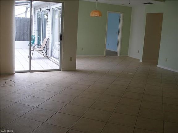 The great room features two sliders, one from the living area and one from the dining area, out to your private screened lanai.