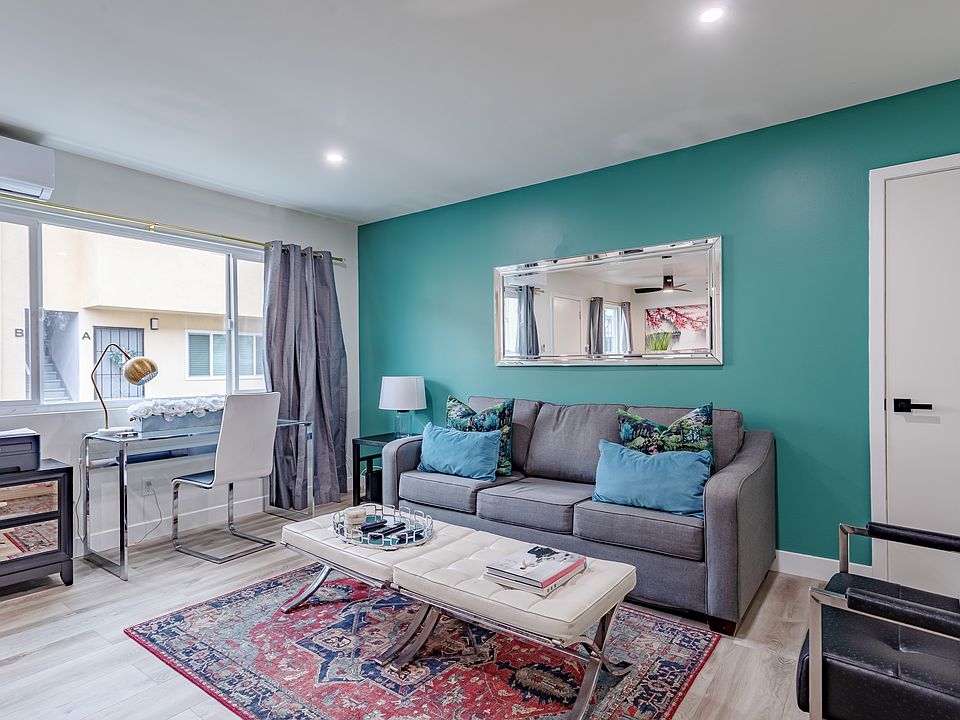 Cozy and inviting living room with plenty of natural light, perfect for unwinding after a long day.