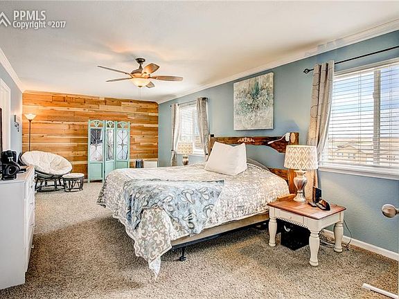 Crown Molding and Wood Accent Wall Give The Master A Modern Elegance.