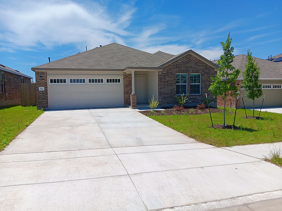 Front of home with one of the 4 bedrooms over looking the front flower bed.