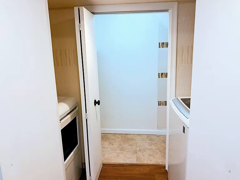 Large washer and dryer are in-unit. Next to the laundry is a dedicated storage space.